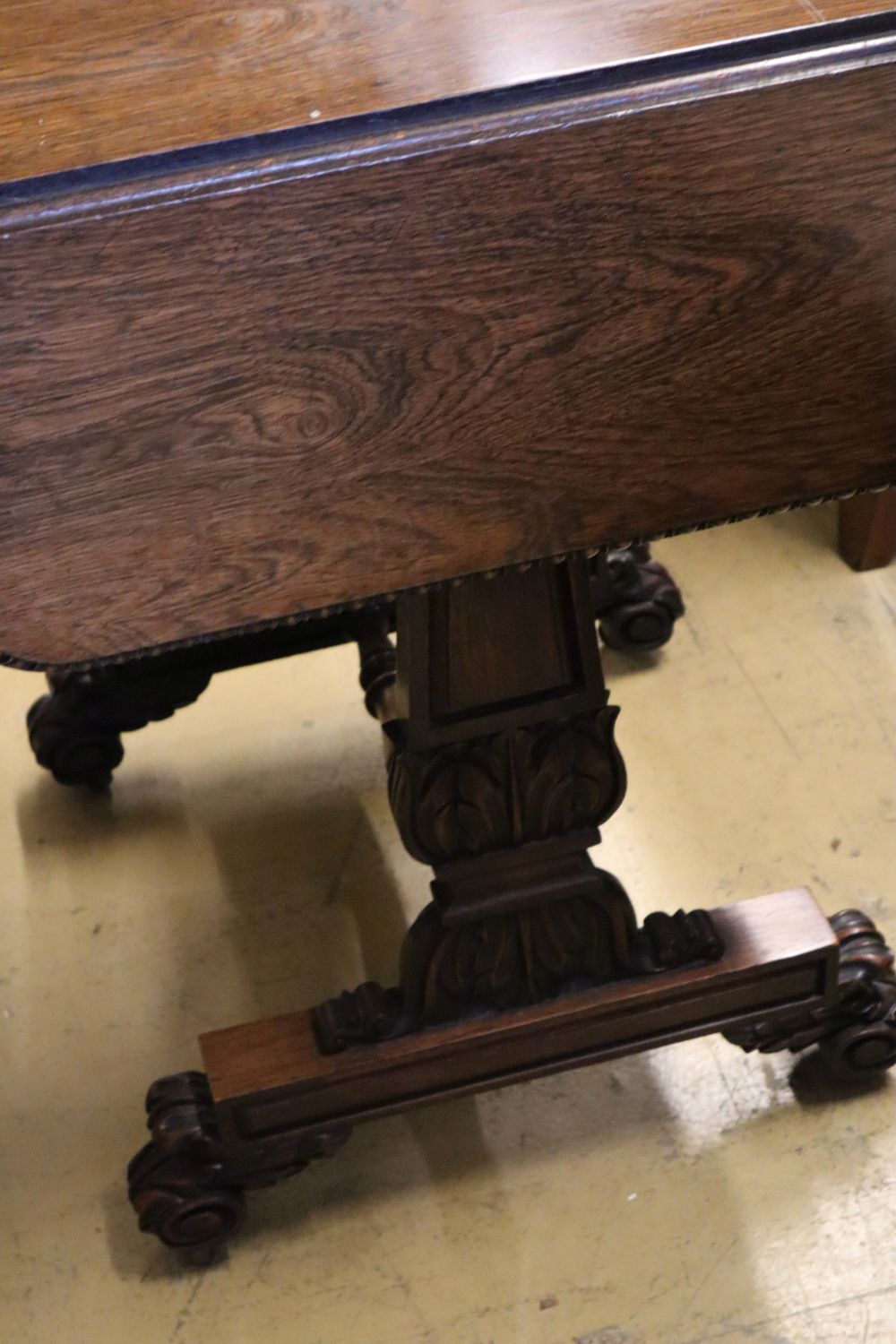 A William IV rosewood drop-flap sewing table, fitted two frieze drawers, carved with acanthus to end supports and feet, width 53cm dept